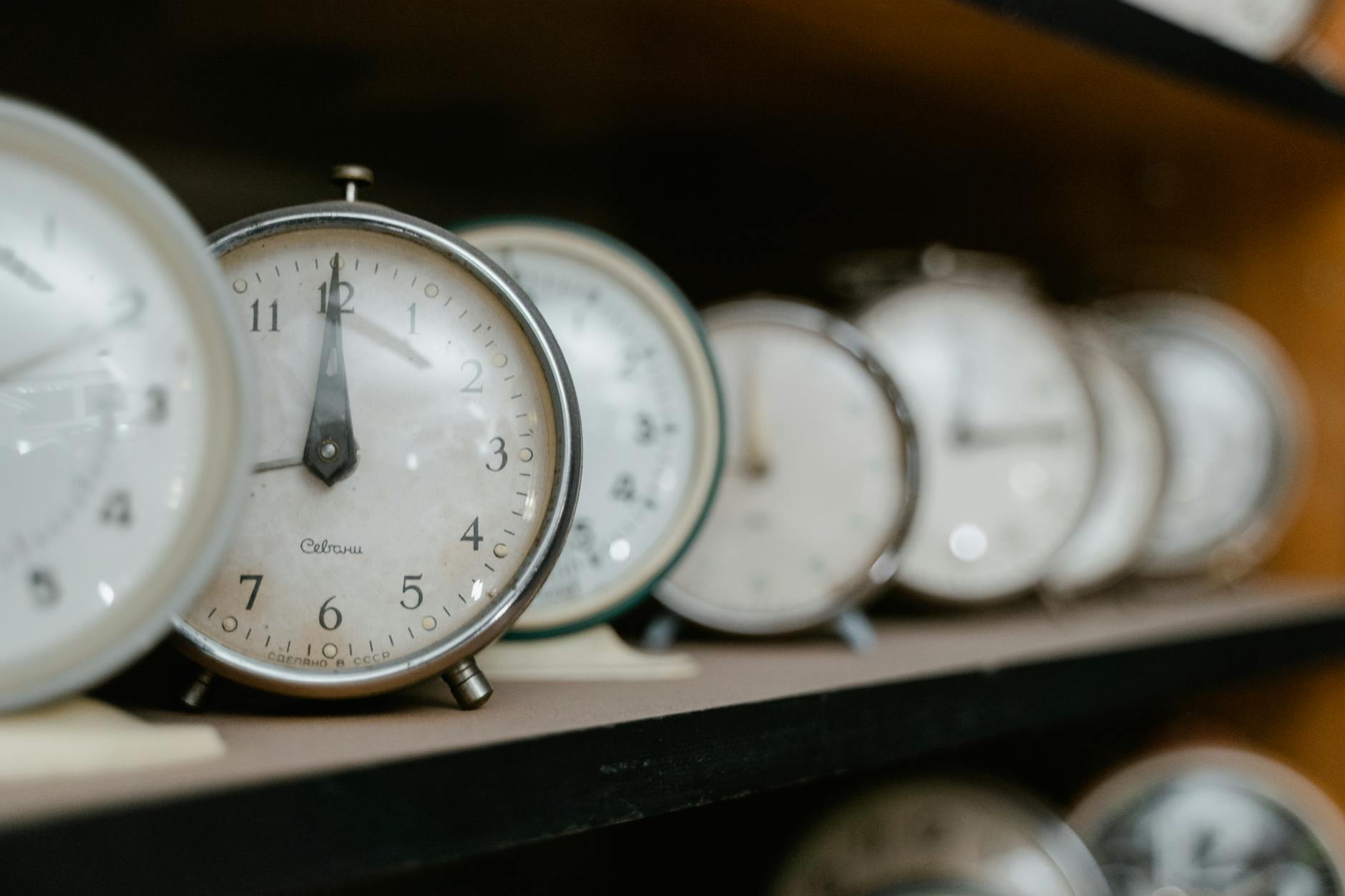 A row of clocks on a shelf metaphorically suggest that there is "time enough at last."