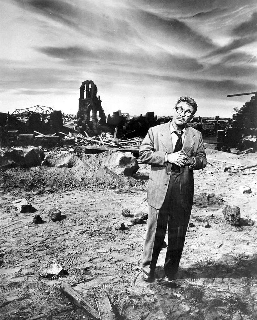 A picture from the Twilight Zone episode, "Time Enough at Last," shows a man standing in the ruined remains of a city.
